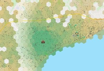 A rental map of Limassol covered in hexagonal blocks: they arrive grey while 598 of them are routed, then fill with a green-to-tan gradient ranking each block by the hours a week a family would spend travelling from it, and lines are drawn from the greenest blocks to the pinned work, gym and school.